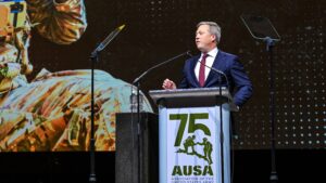 Man speaking behind a podium on stage